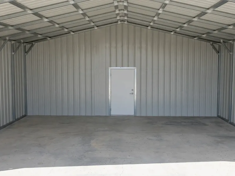 Inside an enclosed metal building with a walk-in door